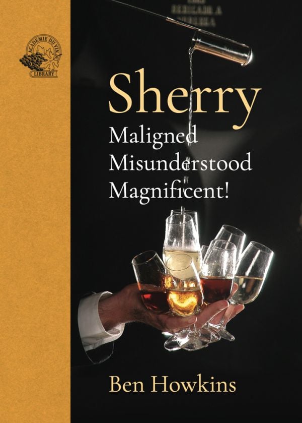 Book cover of Sherry, Maligned*Misunderstood*Magnificent!, featuring a bartender's hand holding 8 sherry glasses while pouring sherry. Published by Academie du Vin Library.
