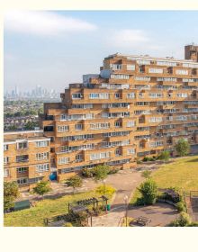 Tower block with pebble-dash sections and frosted glass panels where staircase is located, on cover of 'The Council House', by Hoxton Mini Press.