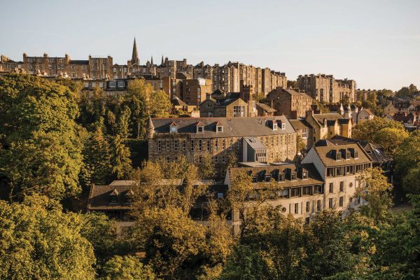 Book cover of Liz Schaffer's Slow Travel Britain, with hiker in middle of forest looking up. Published by Hoxton Mini Press.