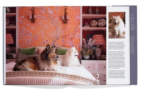 Book cover of Georgina Montagu's Top Dogs: A British Love Affair, with a castle guard in purple coat standing with an Irish wolfhound. Published by Triglyph Books.