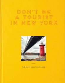Yellow book cover of Don't Be a Tourist in New York, with a little red lighthouse under great gray bridge on Hudson River. Published by 13 Things Ltd.