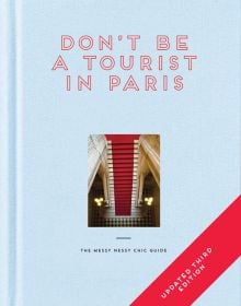 Aerial view of red stairs leading down to black and white checked tiled floor, on pale blue cover of 'Don't be a Tourist in Paris', by 13 Things Ltd.