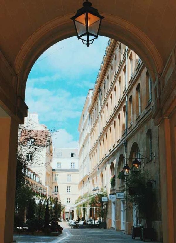 Book cover of Don't be a Tourist in Paris. with an aerial view of red stairs leading down to black and white checked tiled floor. Published by 13 Things Ltd.