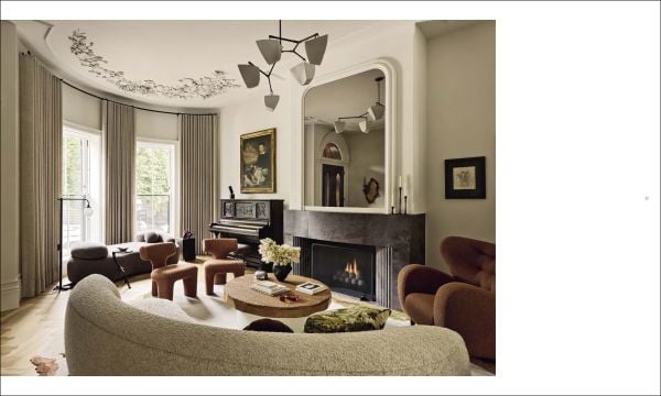 Book cover of Stories of Home: Residential Designs by Hacin; showcasing a modern living room with a fireplace, contemporary lighting, and warm-toned furnishings. Published by Images Publishing.