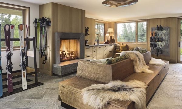 Book cover of Stories of Home: Residential Designs by Hacin; showcasing a modern living room with a fireplace, contemporary lighting, and warm-toned furnishings. Published by Images Publishing.