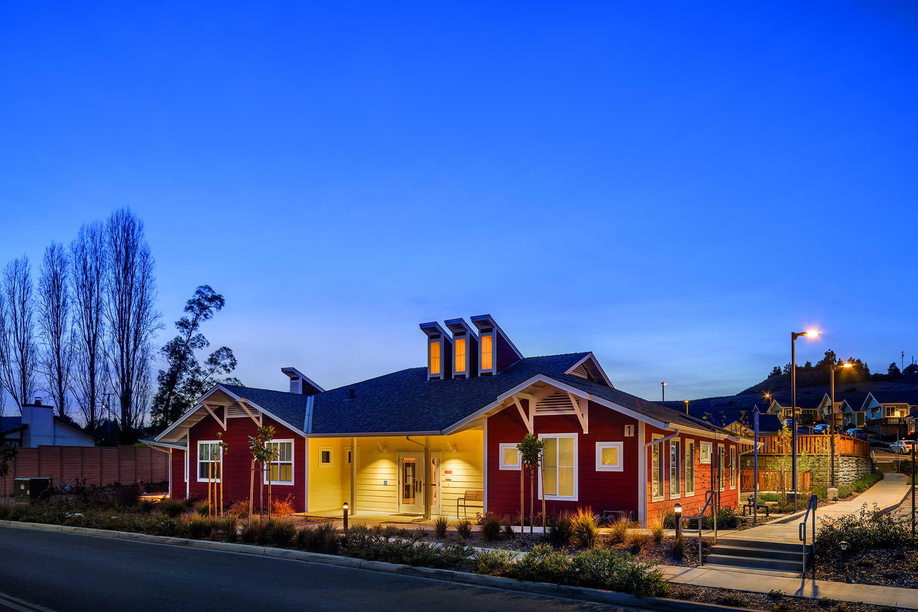 Urban housing estate surrounded by hilly landscape, A solution to homelessness in your town Valley View Senior Housing Napa County California in blue font above.