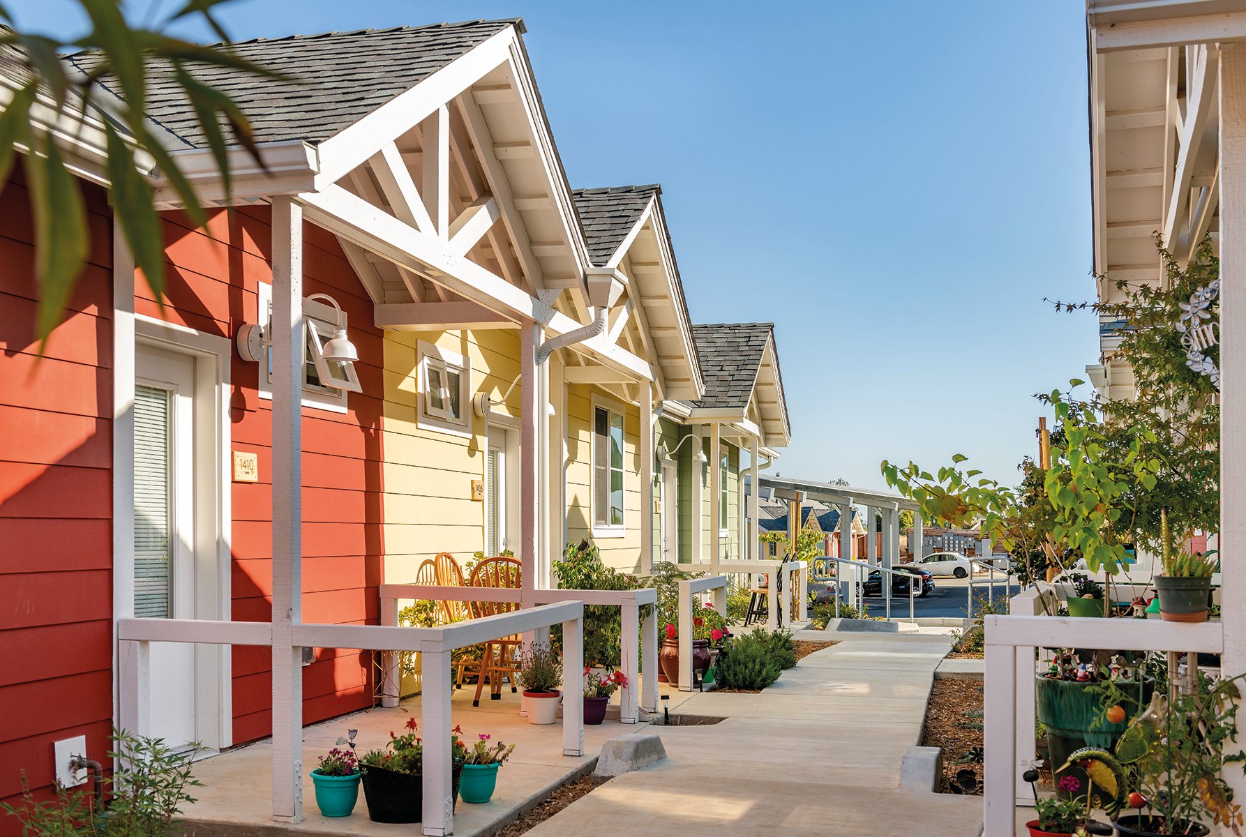 Urban housing estate surrounded by hilly landscape, A solution to homelessness in your town Valley View Senior Housing Napa County California in blue font above.