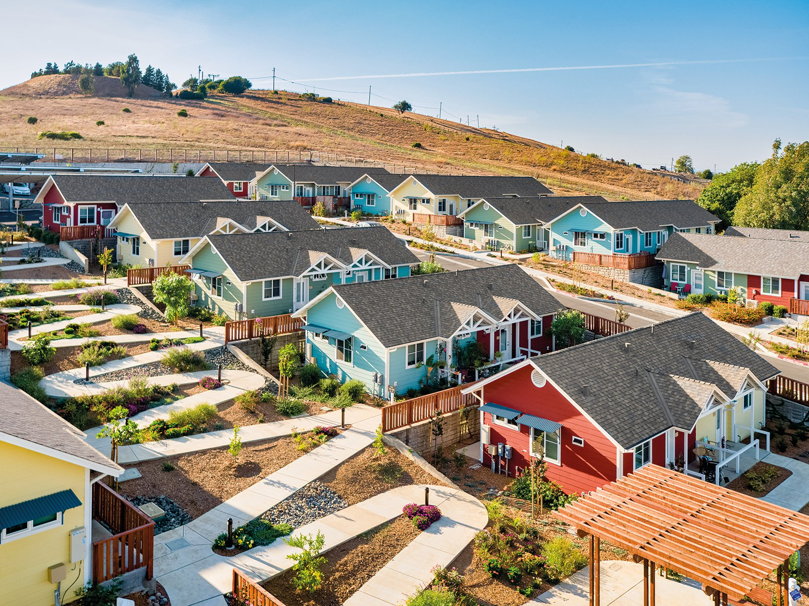 Urban housing estate surrounded by hilly landscape, A solution to homelessness in your town Valley View Senior Housing Napa County California in blue font above.