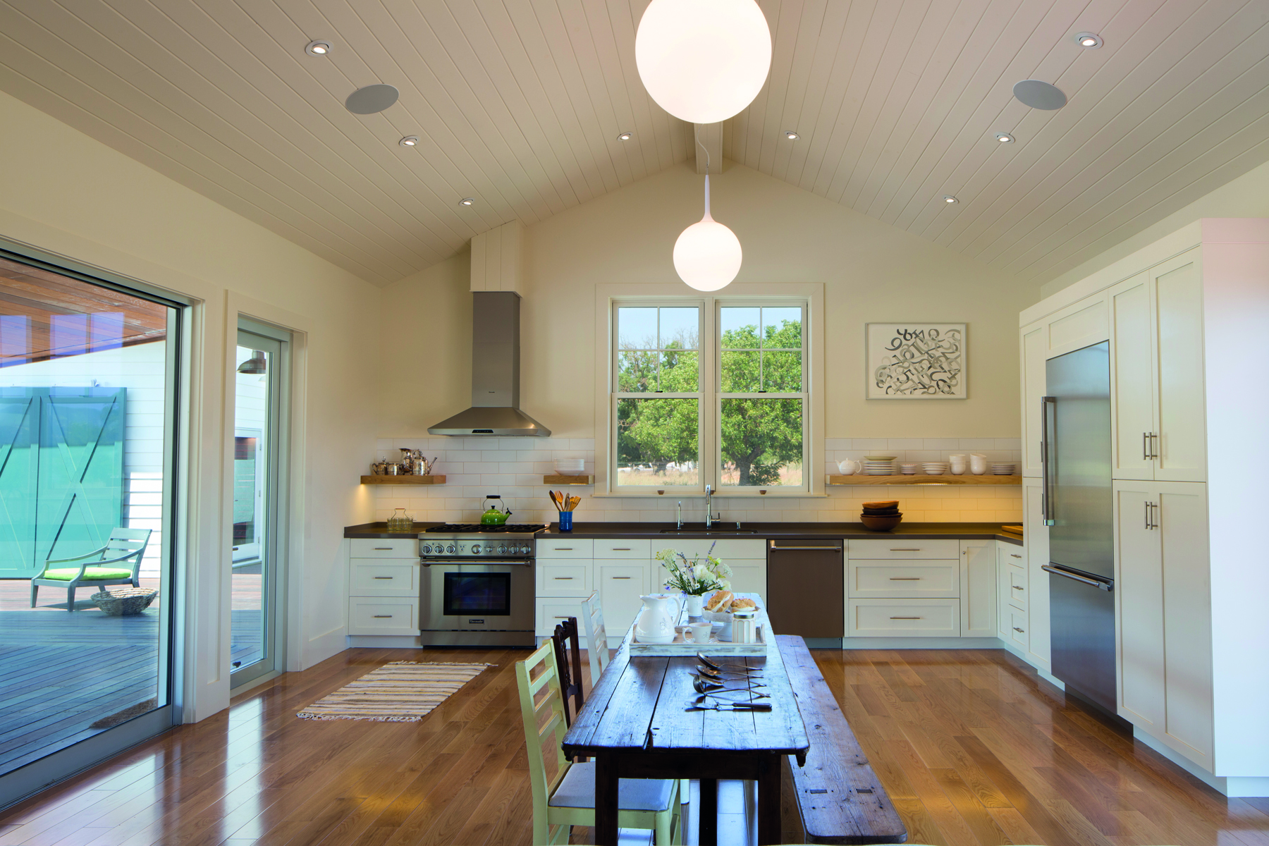 Single storey wood house with low steps leading to swimming pool, Pacific Modern in white font above