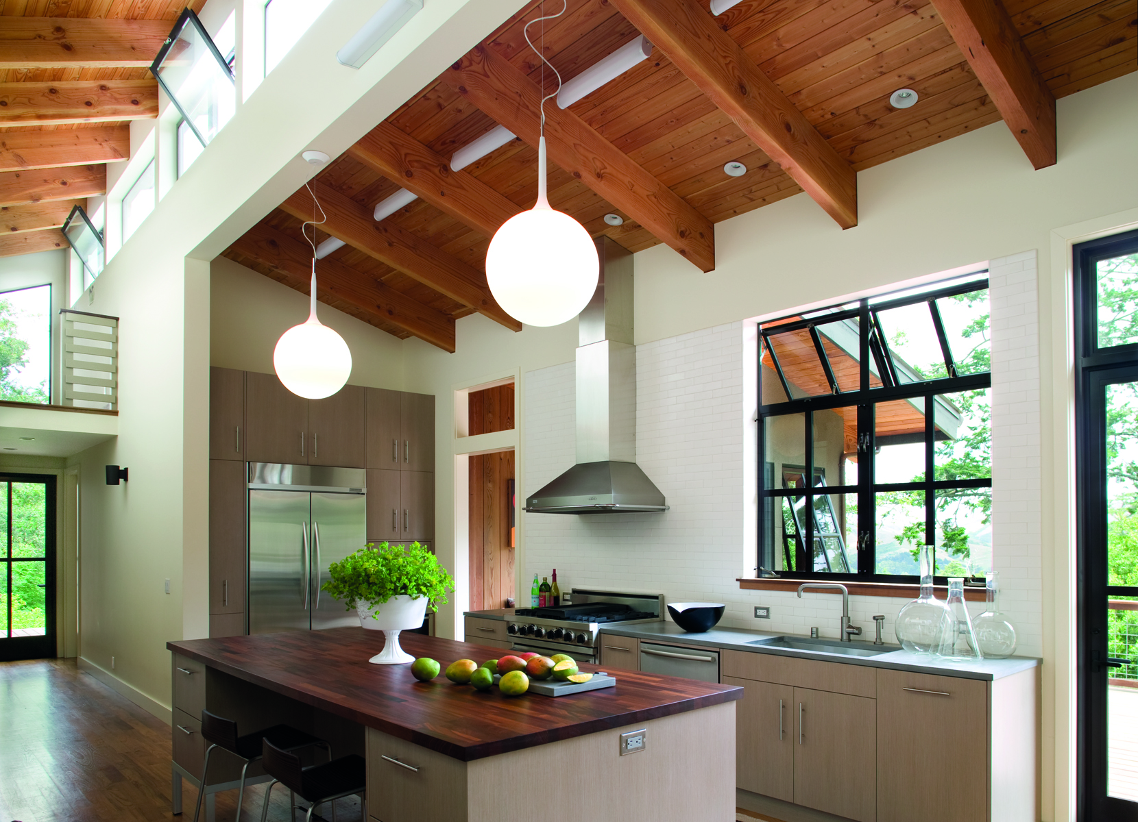 Single storey wood house with low steps leading to swimming pool, Pacific Modern in white font above