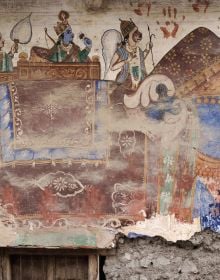 Fresco painting of Indian female, holding pot on head, brown handprint with Fantastic State of Ruin in black font above