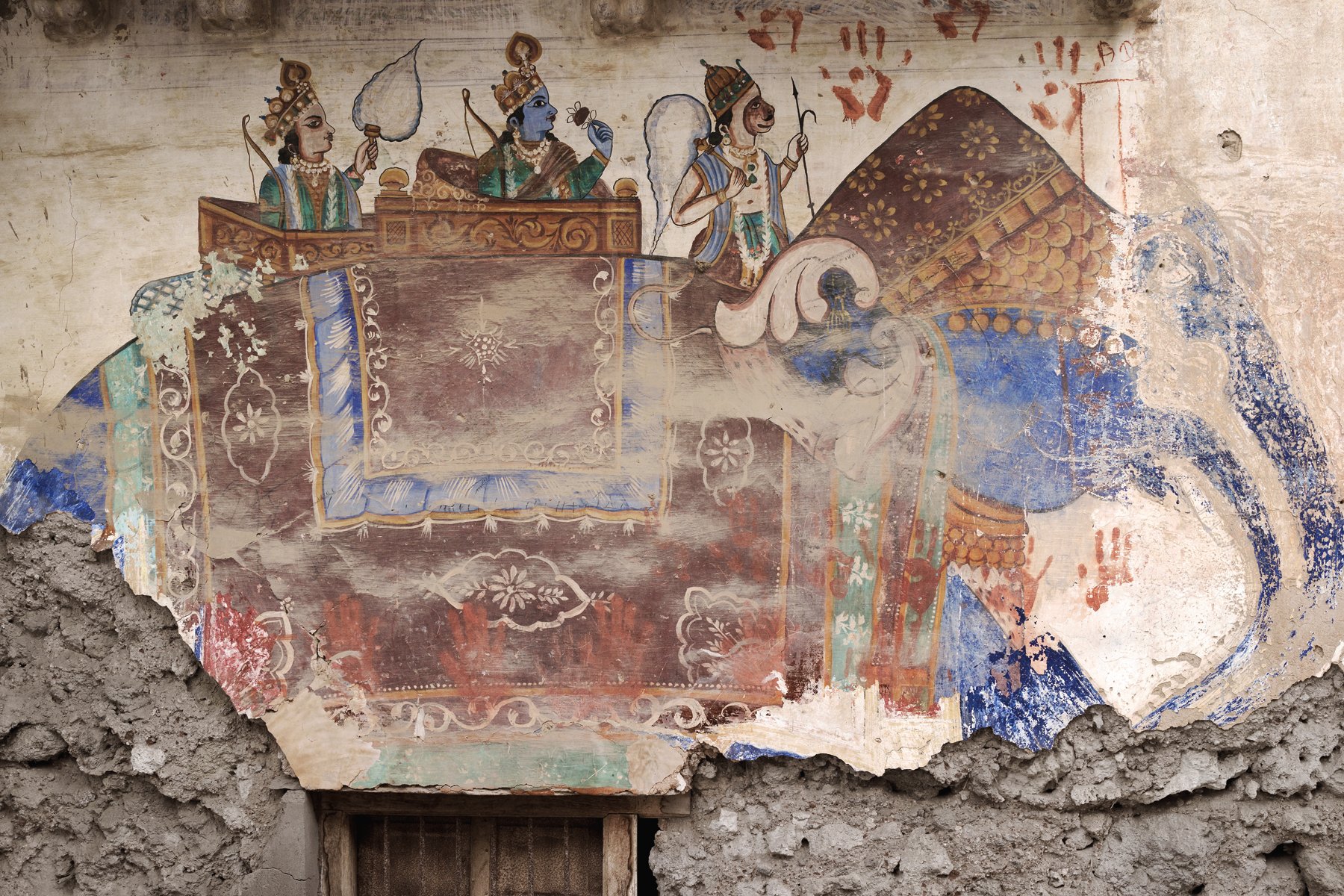 Fresco painting of Indian female, holding pot on head, brown handprint with Fantastic State of Ruin in black font above