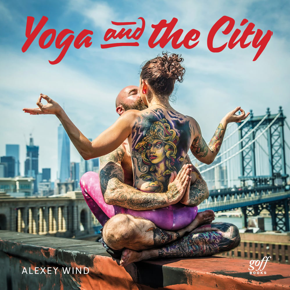 Heavily tattooed couple embracing in yoga pose, on city bridge, Yoga and the City in red font above