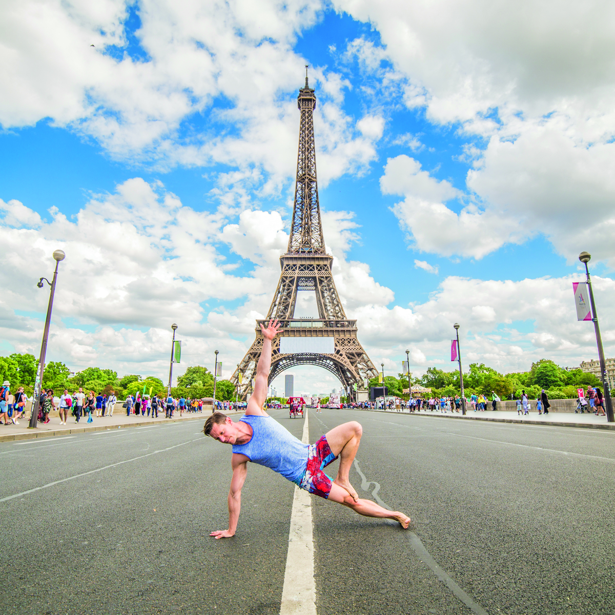 Heavily tattooed couple embracing in yoga pose, on city bridge, Yoga and the City in red font above