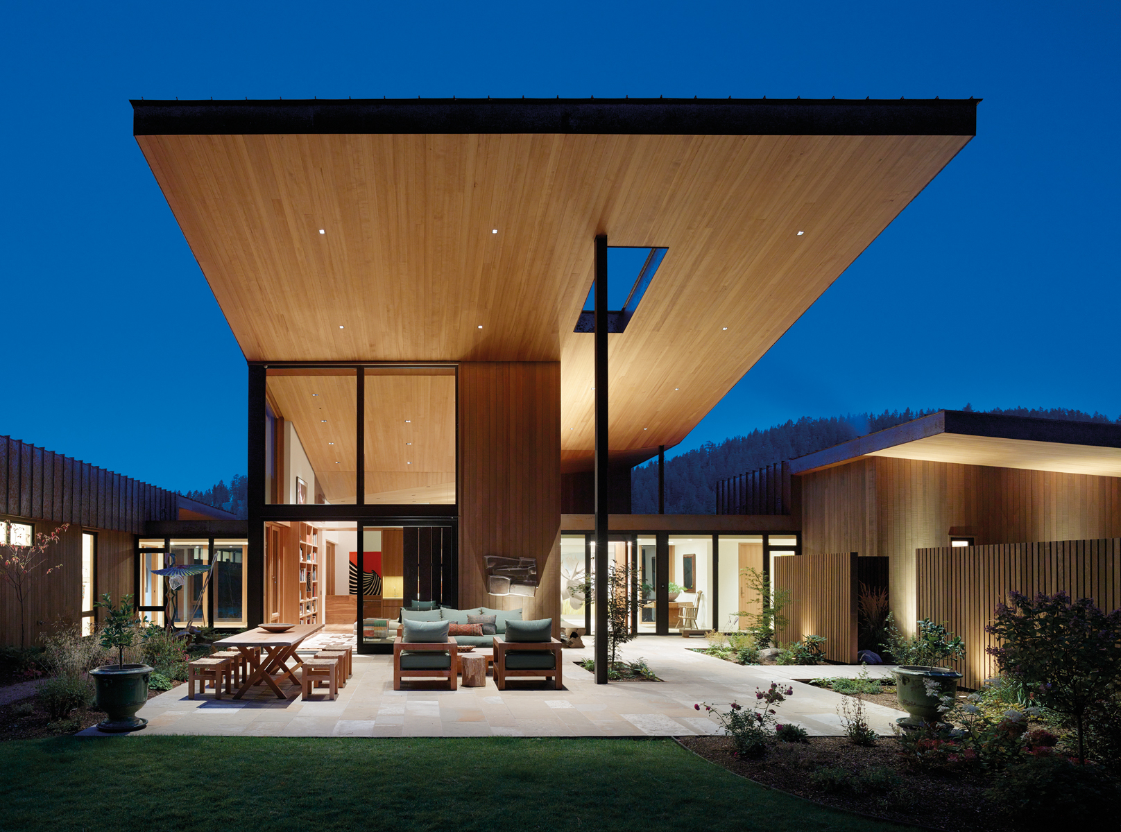 Contemporary flat roof building near lake and autumn trees, Inspired by Place Architects CLB in brown font above by Oro Editions.