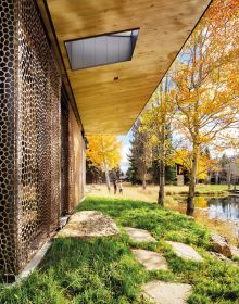 Contemporary flat roof building near lake and autumn trees, Inspired by Place Architects CLB in brown font above by Oro Editions.