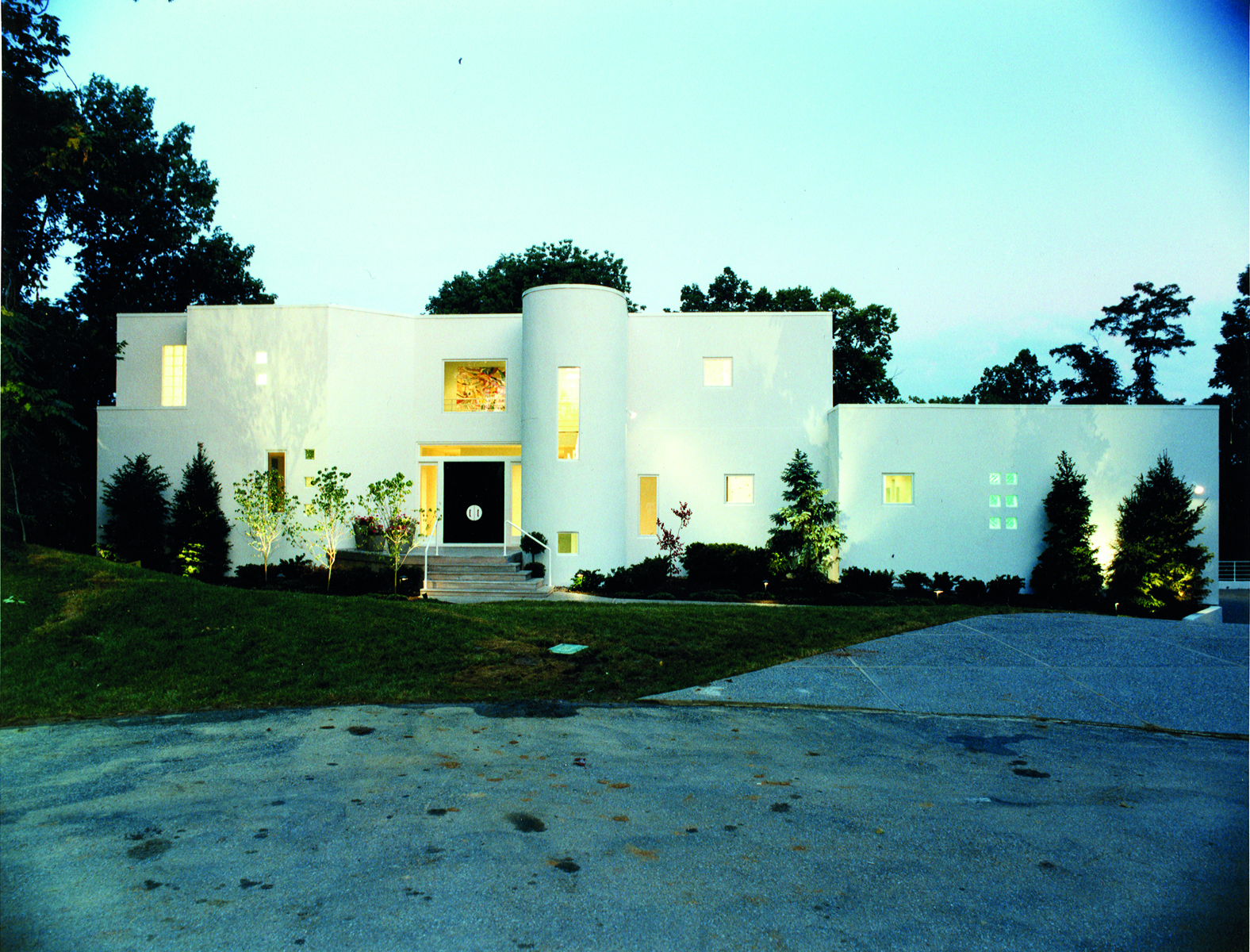 Modern residential home, multiple ridge roof peaks, in green American landscape, CLOSE TO HOME in white font on top green banner.