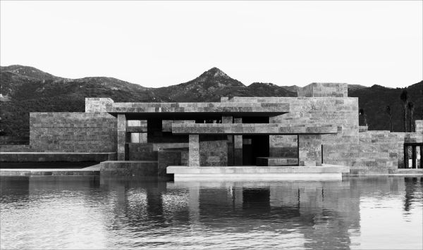 Low angled shot of interior building, Emre Arolat Scent of the Trace in white font above.