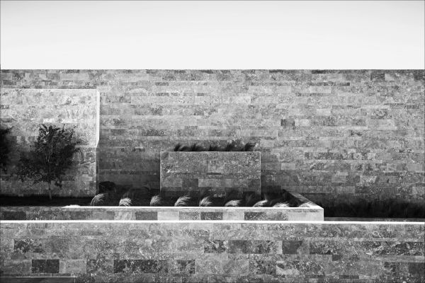 Low angled shot of interior building, Emre Arolat Scent of the Trace in white font above.