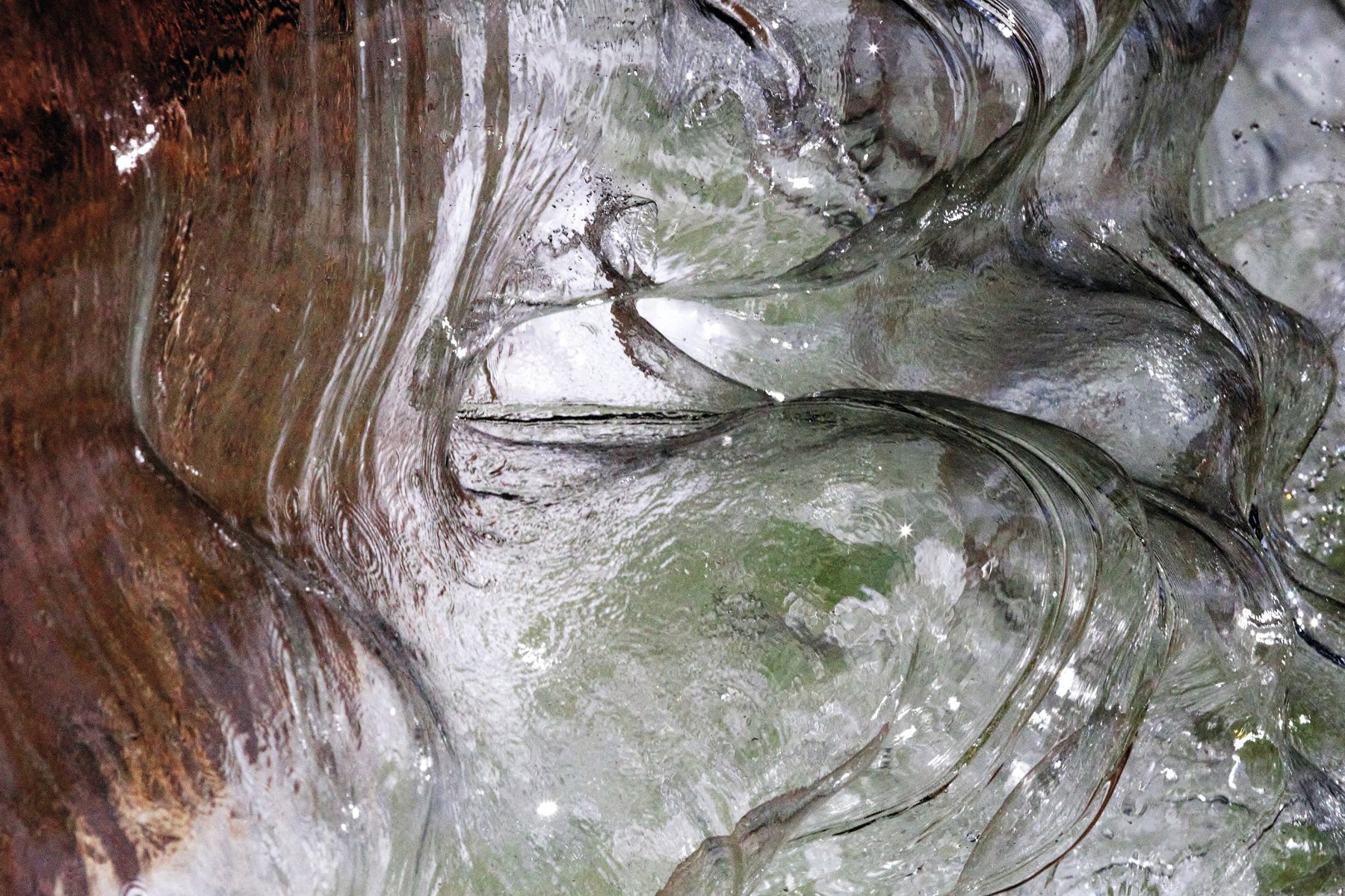 Photograph of flowing water across blue cover, Liquid Poetry The Wonder of Water in white font above