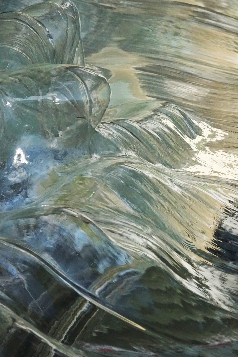 Photograph of flowing water across blue cover, Liquid Poetry The Wonder of Water in white font above