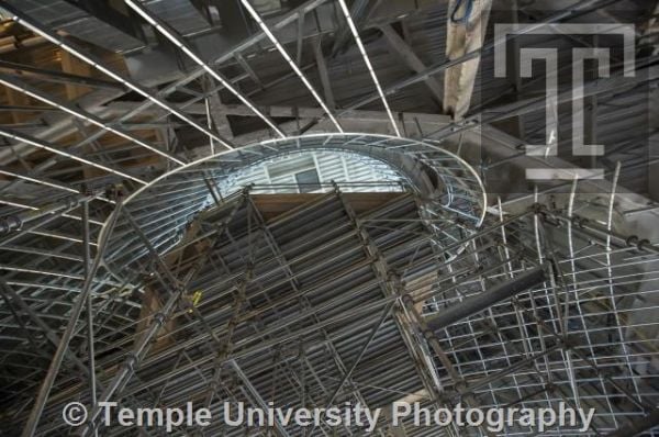 Modern curved wood and glass architectural structure, Library at Stoa Snohetta Public Space and Academic Mission in the Charles Library in white font.