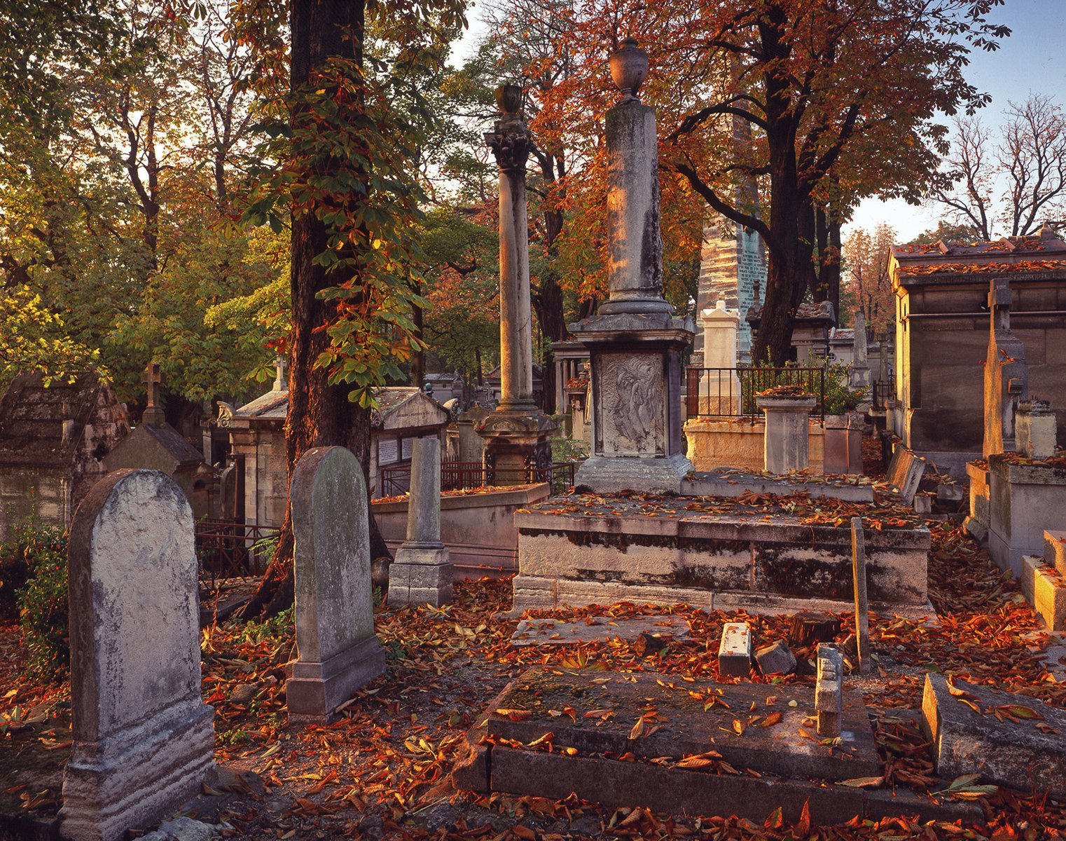 Tomb of Antoine-Gaëtan Guérinot, carved sculpture of robed woman, CITY OF IMMORTALS in white font on central grey transparent banner.