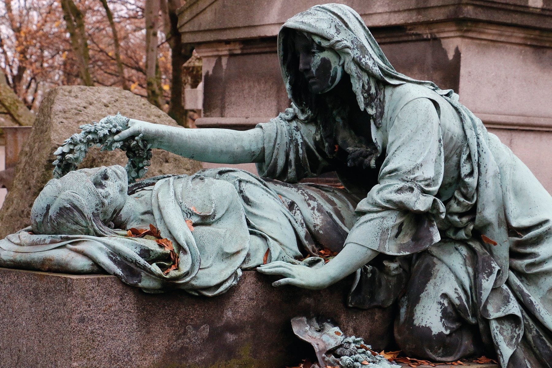 Tomb of Antoine-Gaëtan Guérinot, carved sculpture of robed woman, CITY OF IMMORTALS in white font on central grey transparent banner.