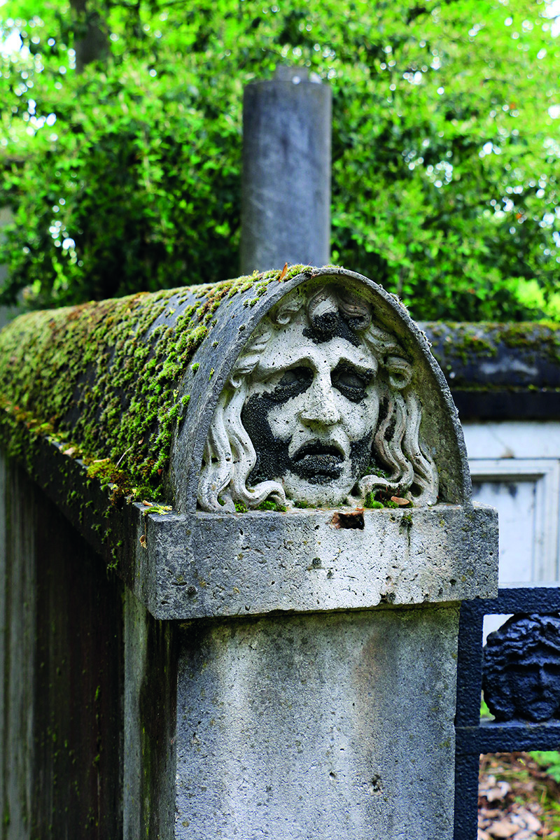 Tomb of Antoine-Gaëtan Guérinot, carved sculpture of robed woman, CITY OF IMMORTALS in white font on central grey transparent banner.