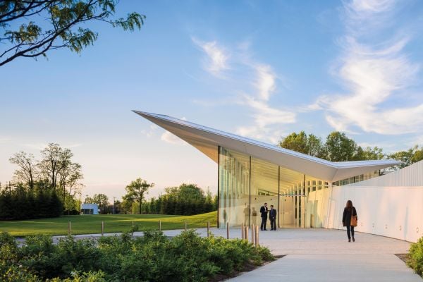 3 photos of modern architectural structures down left edge, women (re) build STORIES POLEMICS FUTURES in white and pink font on black cover.