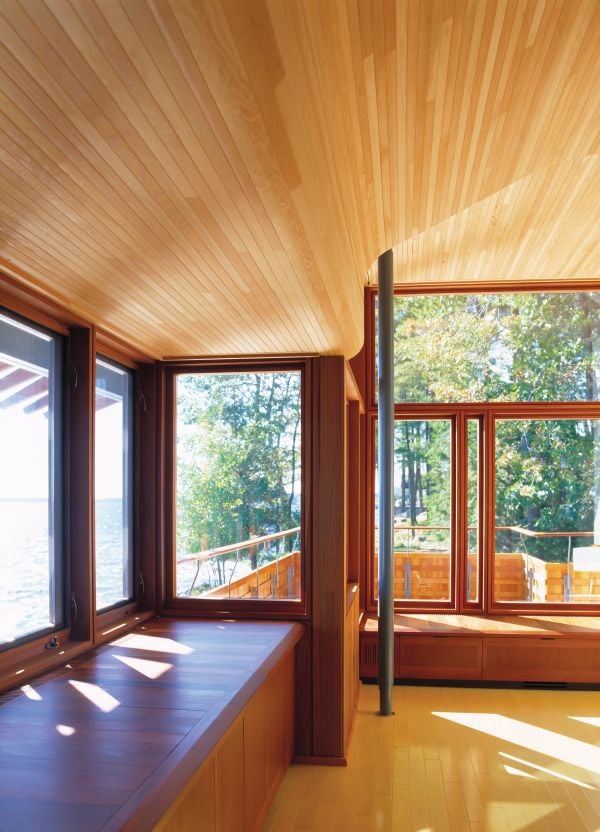 2 modern wooden buildings by Lake Muskoka, large trees and moss covered ground, The Architecture of Point William Shim Sutcliffe in white font to lower left.