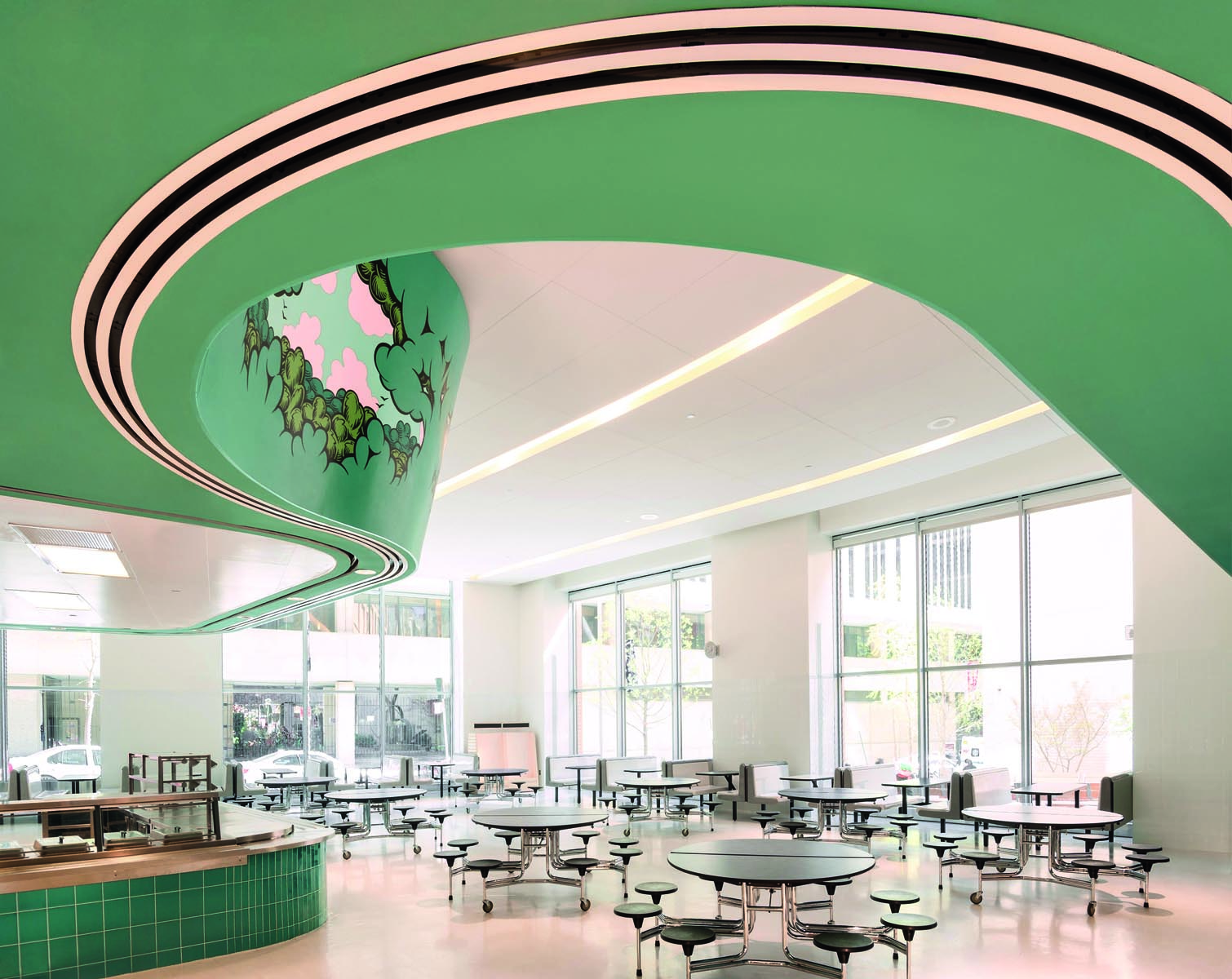 Elm tree elementary school, rainbow swirls on white tiled surface wall, Building Great Schools for a Great City in white font to upper left.