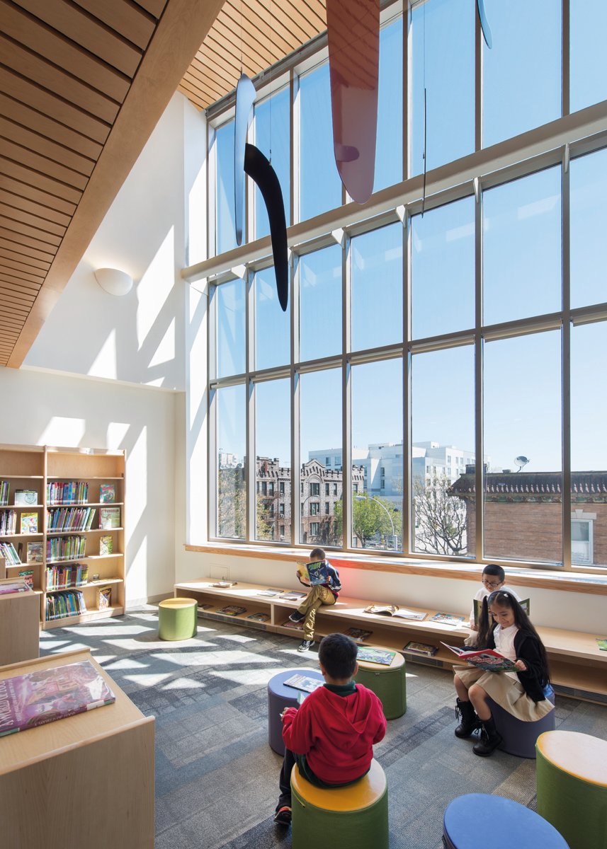 Elm tree elementary school, rainbow swirls on white tiled surface wall, Building Great Schools for a Great City in white font to upper left.