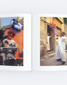 Book cover of Inflatable Planet, with two men in traditional dress, with one leaning on stick, both wearing inflated balloon crowns on their heads. Published by ORO Editions.