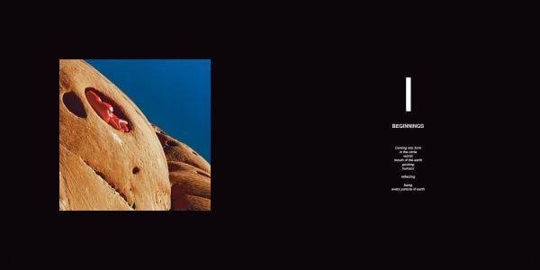 2 nude figure in red body paint and blue hair, 1 standing holding mannequin's legs, 1 sitting on edge of circular pool, blue cover, BODY MIRROR in white font above.