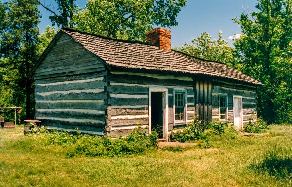 Stone dragon gargoyle on side of building, blue sky behind, ARCHES TO ZIGZAGS An Architectural ABC in white font above and below.