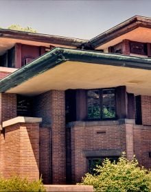 Stone dragon gargoyle on side of building, blue sky behind, ARCHES TO ZIGZAGS An Architectural ABC in white font above and below.