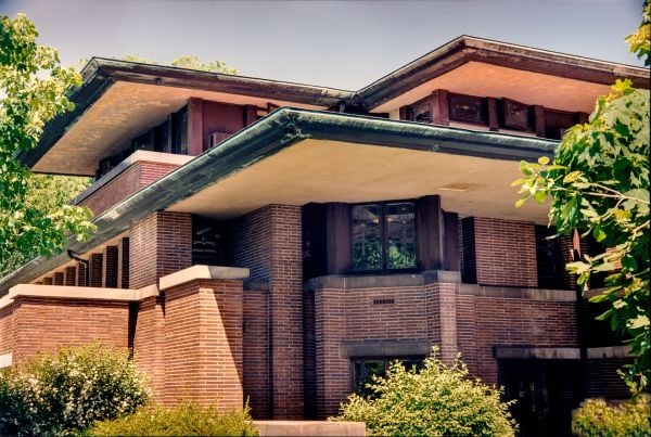 Stone dragon gargoyle on side of building, blue sky behind, ARCHES TO ZIGZAGS An Architectural ABC in white font above and below.