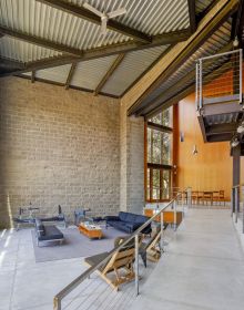 Single flat roof building illuminated by exterior lights under dusk blue sky with Framing The Valley in white font above
