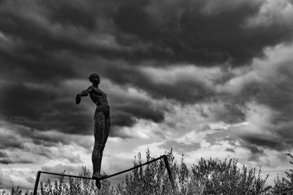 Book cover of Think Before You Shoot, with a man in trilby, sitting in street, holding cup to lips, with old box camera. Published by ORO Editions.