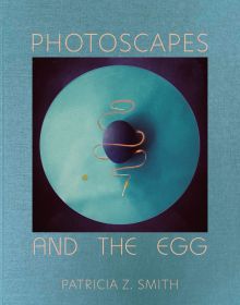 Aerial image of dark blue egg on blue circle, PHOTOSCAPES AND THE EGG, in beige font to top and bottom of blue cover.