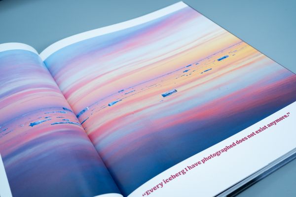 Book cover of Seeing It All, Women Photographers Expose our Planet, with a large iceberg floating on sea, under orange sky. Published by ORO Editions.