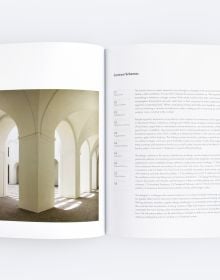 Book cover of Experiential Design Schemas, with a figure sitting cross-legged on cushion, in domed building space with strip of light above. Published by ORO Editions.