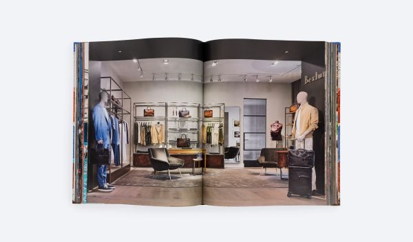 Brick wall painted with colourful triangular shapes, on cover of 'Droese Raney x Design', by ORO Editions.