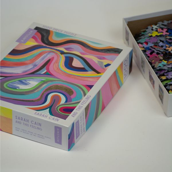 Box of and this feeling: 1000 piece puzzle; featuring a brightly-colored artwork. Published by Kinstler.