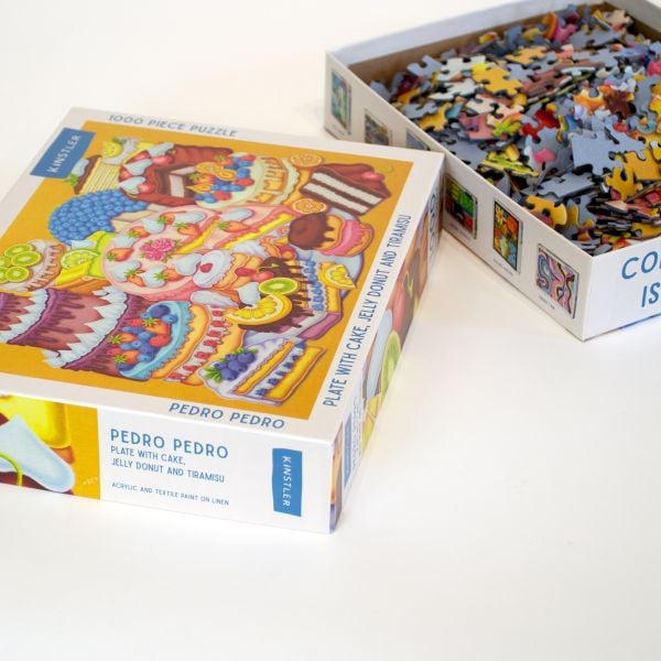 Puzzle box of Plate with Cake, Jelly Donut and Tiramisu: 1000 piece puzzle. Published by Kinstler.