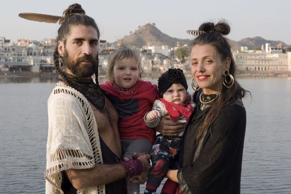 Book cover of David Zurick's Hippie India: Dreamers and Seekers in the Land of Nirvana, with a wall mural of two figures with their eyes closed. Published by ORO Editions.