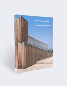 Book cover of Between Light and Shadow: The Work of Maryann Thompson, featuring a building with wood slates to exterior. Published by ORO Editions.