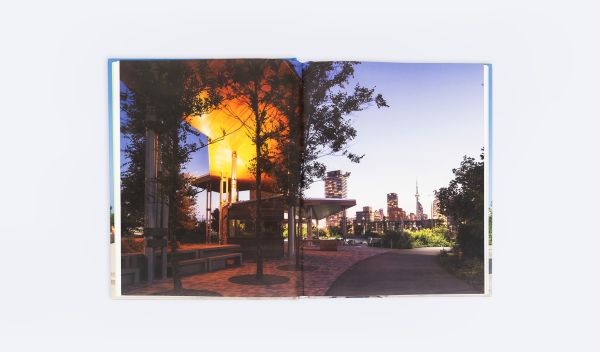 Book cover of Between Light and Shadow: The Work of Maryann Thompson, featuring a building with wood slates to exterior. Published by ORO Editions.