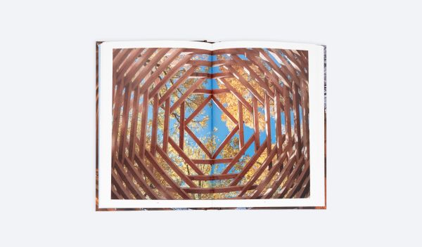 Book cover of Ispace: A Journey Into Emotions; featuring a wooden structure. Published by ORO Editions.